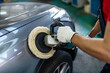 © zinkevych - Male hands with polishing machine on surface of car