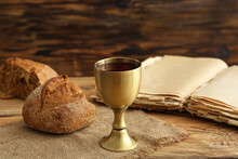 Chalice Of Wine With Bread And Holy Bible On Wooden Background