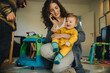 © Jacob Lund - Mother holding baby while talking on phone