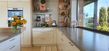 Wooden Top On Background Of Modern Kitchen With Window And Shelves.