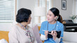 © ChayTee - Young asia female nurse, assisted living, in-home carer or doctor visit old senior citizen at home talk about result follow up checklist, health care advice or prescription online on tablet computer.
