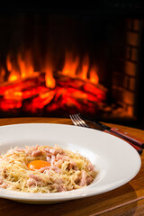 Sticker - Pasta Carbonara on white plate with parmesan and yolk on dark background