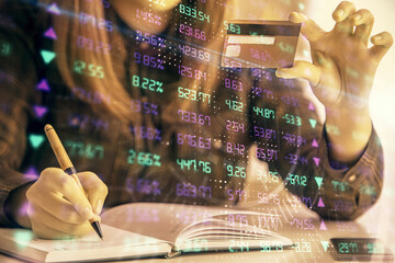 Poster - Multi exposure of woman on-line shopping holding a credit card and financial graph drawing. Stock market E-commerce concept.