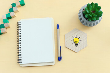 Wall Mural - top view image of open notebook with blank pages on wooden yellow pastel background. ready for adding text or mockup.