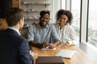 © fizkes - Close up happy smiling African American young couple listening to manager financial advisor realtor at meeting, businessman consulting family about contract terms, investment or insurance