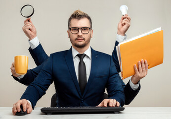 businessman with many hands in a suit. works simultaneously with several objects, a mug, a magnifyin