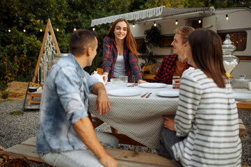 Wall Mural - young friends relax on picnic at camping