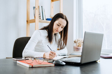 Wall Mural - Remote Accounting Finance Jobs. Online Accounting Solution. Candid portrait of female accountant working with laptop, calculator and documents at home office