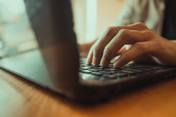 Close focus of man's hands typing. Man working at home office hand on keyboard close up