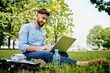 © baranq - Portrait of young entrepreneur working on laptop during lunch break in the park