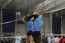 Female Volleyball Players Double Block During An Indoor Match