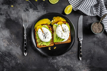 Wall Mural - Poached egg on toast. Sandwich with avocado and Poached Egg. Clean eating. Top view. Copy space