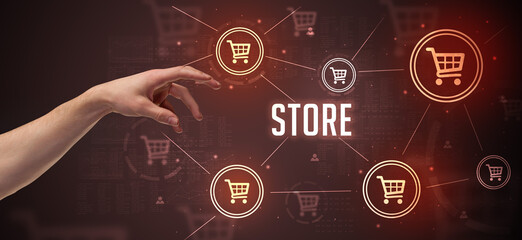 Close-Up of cropped hand pointing at STORE inscription, online shopping concept