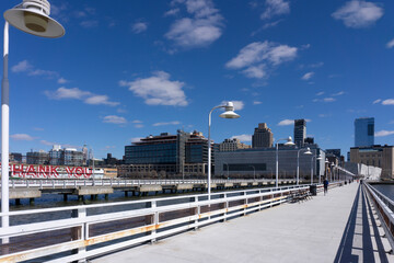 Wall Mural - Pier 34 along Hudson River overlooking Tribeca buildings in Manhattan. New York City skyline view.