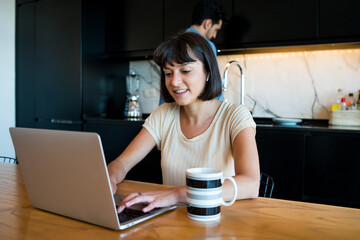 Wall Mural - Young woman working from home.