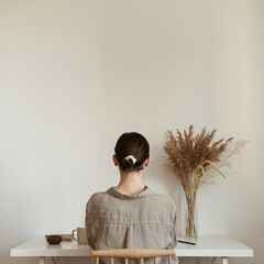 Wall Mural - Working at home concept. Girl working at home. Modern home living room interior design. Girl boss, lady boss..Aesthetic minimalist workspace background. Blog, social media, web, magazine template.