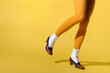 Woman wearing mustard-colored pantyhose and retro tritone shoes