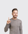 © kite_rin - Smiling handsome man pointing up to product isolated on white background. Young men showing way with finger studio portrait, advertisement concept.