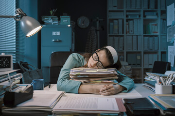 Exhausted office worker sleeping in the office