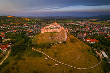 Wall Mural - Sumeg, Hungary - Aerial panoramic view of the famous High Castle of Sumeg in Veszprem county at sunset with storm clouds and small rainbow at background on a summer afternoon