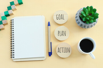 Wall Mural - top view of blank notebook and wooden cubes with the text goal plan action.