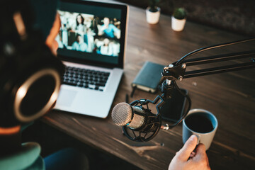 Wall Mural - Content creator streaming his live podcast using professional microphone at his broadcast studio. Top view