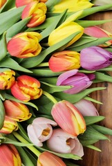  Spring tulips bouquet on wooden background.