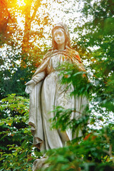Fototapete - Ancient statue of Holy Virgin Mary in light rays.