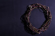 Crown of thorns on purple background.