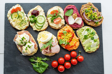 Wall Mural - selection board of open sandwiches dips, spreads, cold cut meat, cheese, egg and salad 