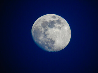 earth's moon glowing with different colours in the background. blue and red moon watched by telescop