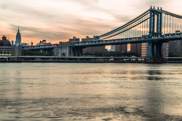 The Brooklyn bridge in  New York with the Manhattan skyline on the background.