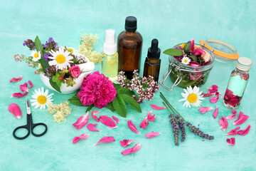 Wall Mural - Natural herbal medicine with summer flowers and herbs infusing in a jar with oil and loose to make aromatherapy essential oil. Still life for naturopathic health care concept.