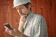 Portrait of concerned male worker using mobile smart phone, reading text message