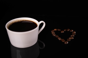 Sticker - Cup of espresso and a heart made of roasted beans on a black background