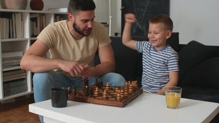 Wall Mural - father play chess with his son at home