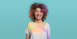 Laughing curly haired woman with Holi paints
