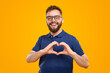 © kegfire - Cheerful bearded man showing heart gesture