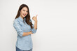 © comzeal - Young Asian woman smiling and pointing finger to empty copy space isolated on white background