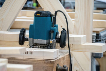 Poster - Vertical cutter in a woodworking workshop. Vertical milling cutter during work. Woodworking and furniture manufacturing. Wood processing with milling machine. Concept - sale of woodworking equipment