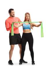 Canvas Print - Male fitness trainer showing an exercise to a woman with an elastic band