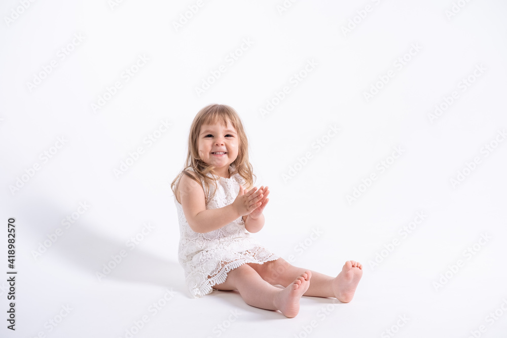 beautiful little girl in white dress sitting on white background Stock ...