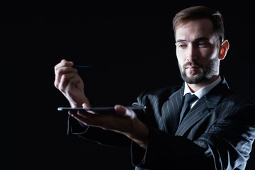 Poster - business communication concept. the businessman holds a tablet and stylus at arm's length. a man in 