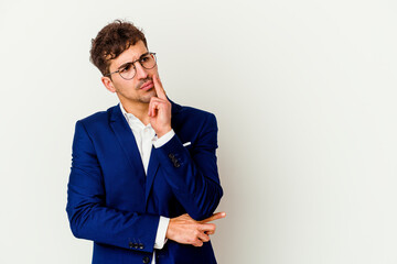 Wall Mural - Young business caucasian man isolated on white background looking sideways with doubtful and skeptical expression.