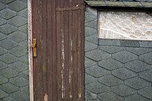 Old Wooden Door And A Window On A Boathouse With Tar Paper