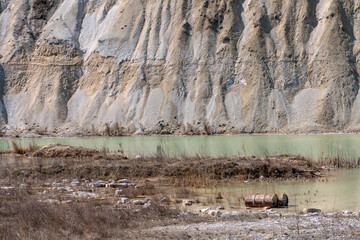 Large sand pit and lake. A flooded old abandoned quarry complex. Extraction of sand and stone for industrial applications.