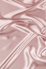 Wall Mural - Beautiful pastel color background with drapery and wavy folds of silk satin material texture. Top view