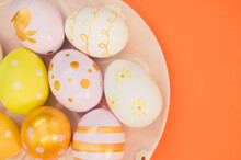 Plate With Decorated Easter Eggs Isolated On Orange Background