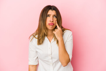 Wall Mural - Young indian woman isolated on pink background crying, unhappy with something, agony and confusion concept.