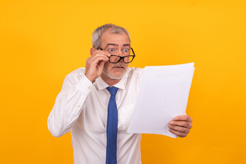 businessman looking surprised at documents isolated